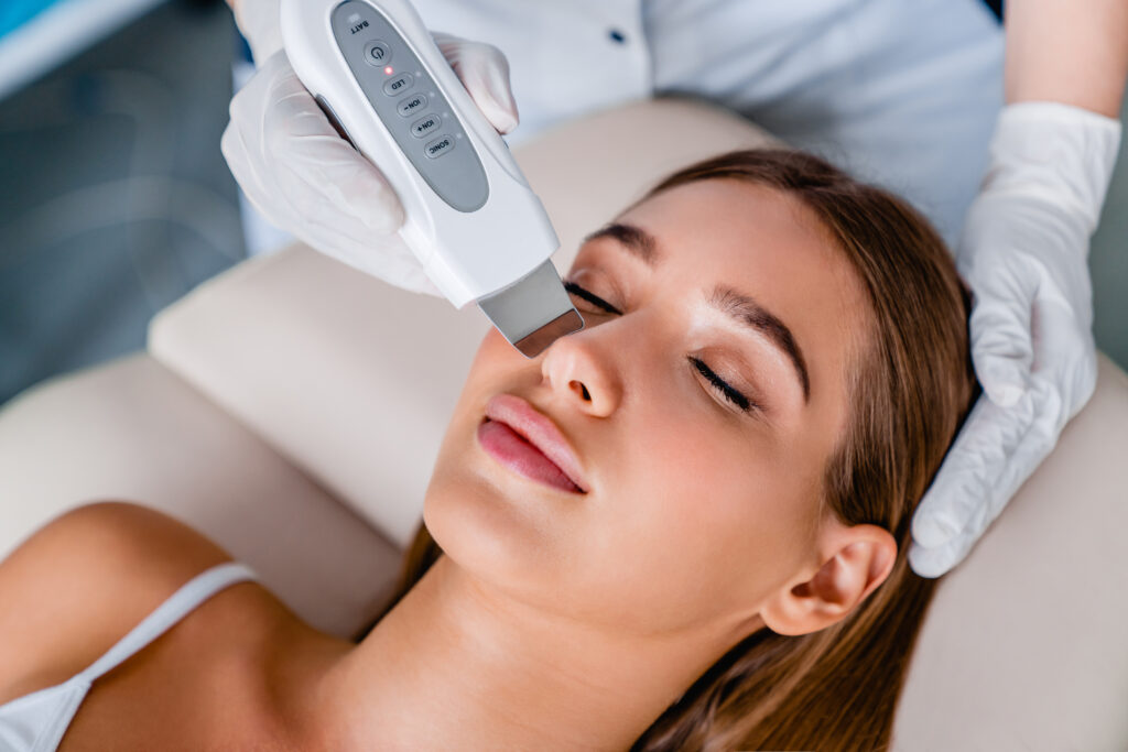 Young woman on ultrasound facial beauty treatment